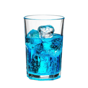 Glass of blue energy drink with ice cubes in the white background.